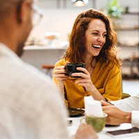 Couple smiling while enjoying coffee together